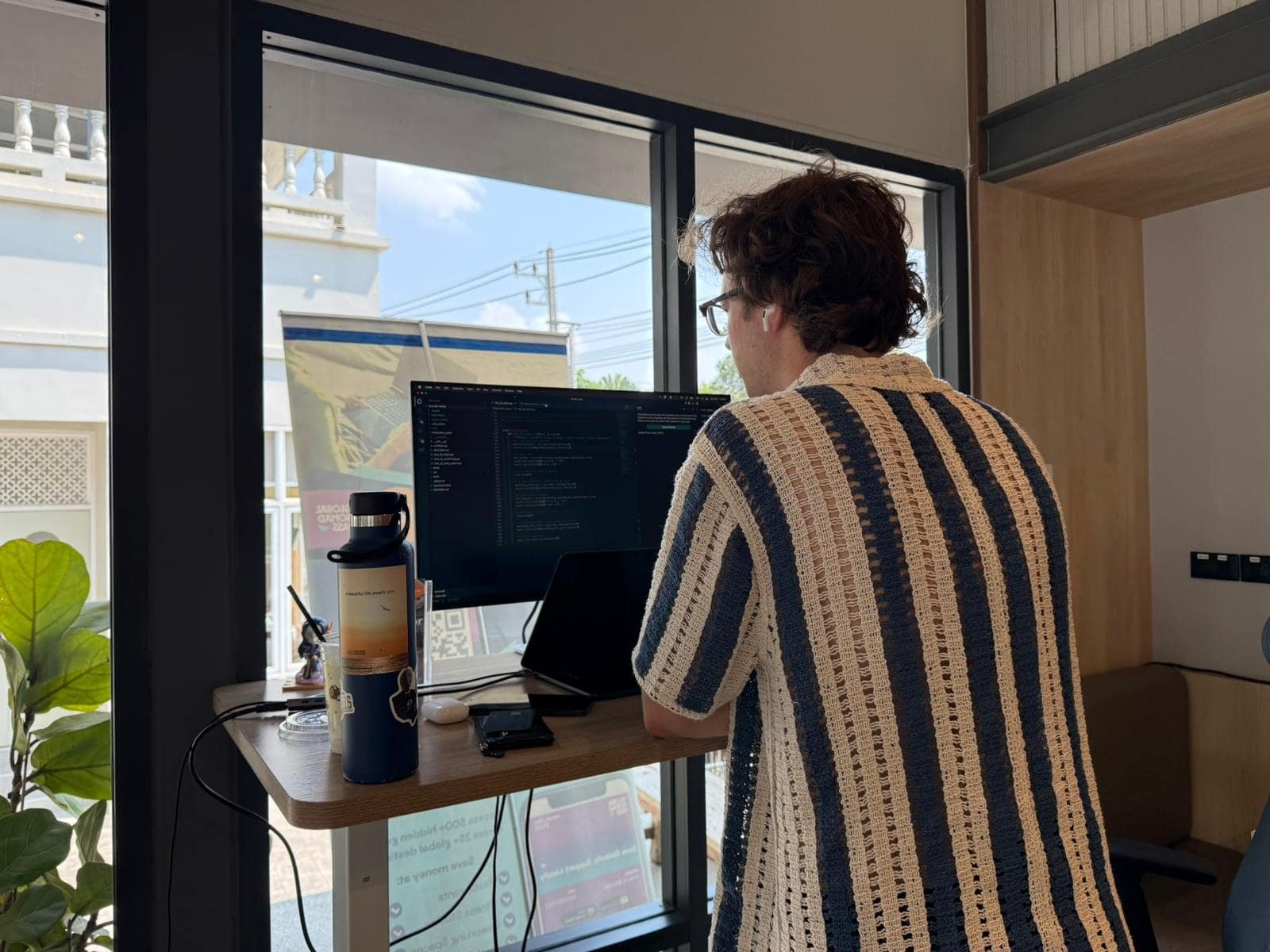 Person coding on a laptop at a Chiang Mai coworking space