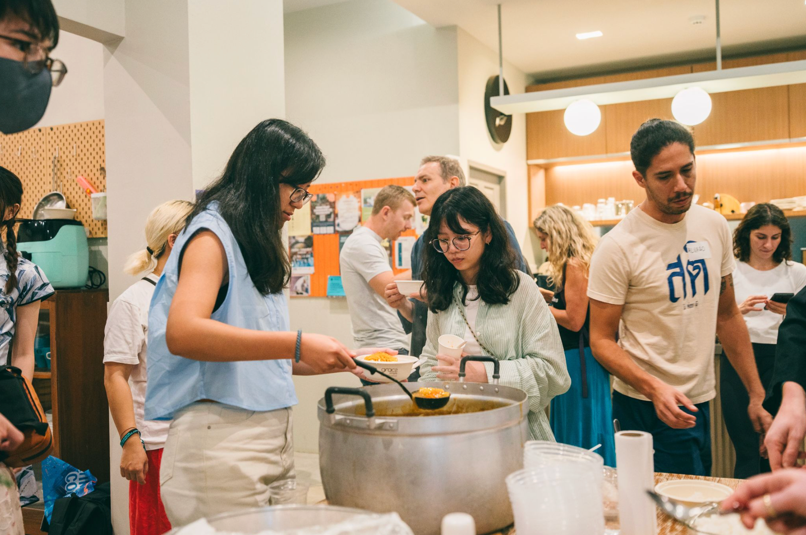 Digital nomads and Chiang Mai locals sharing food at a community pot luck