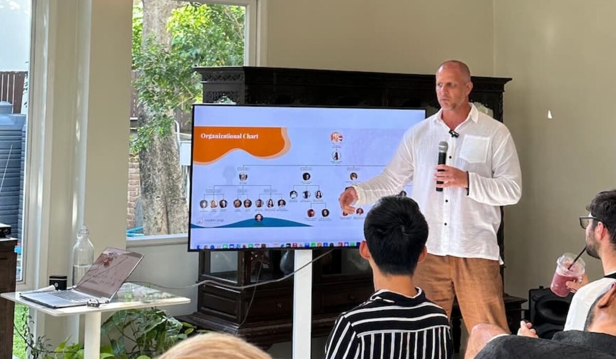 Speaker presenting slides to a small audience at a Cosmo Local CNX session
